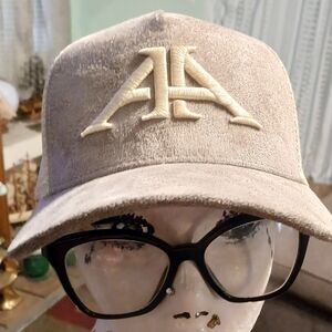 Beige Cap with Embroidered Logo u branded has AA on front sna back suade & mesh